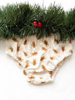 Load image into Gallery viewer, Baby bloomers with gingerbread men pattern on a white background with greenery.
